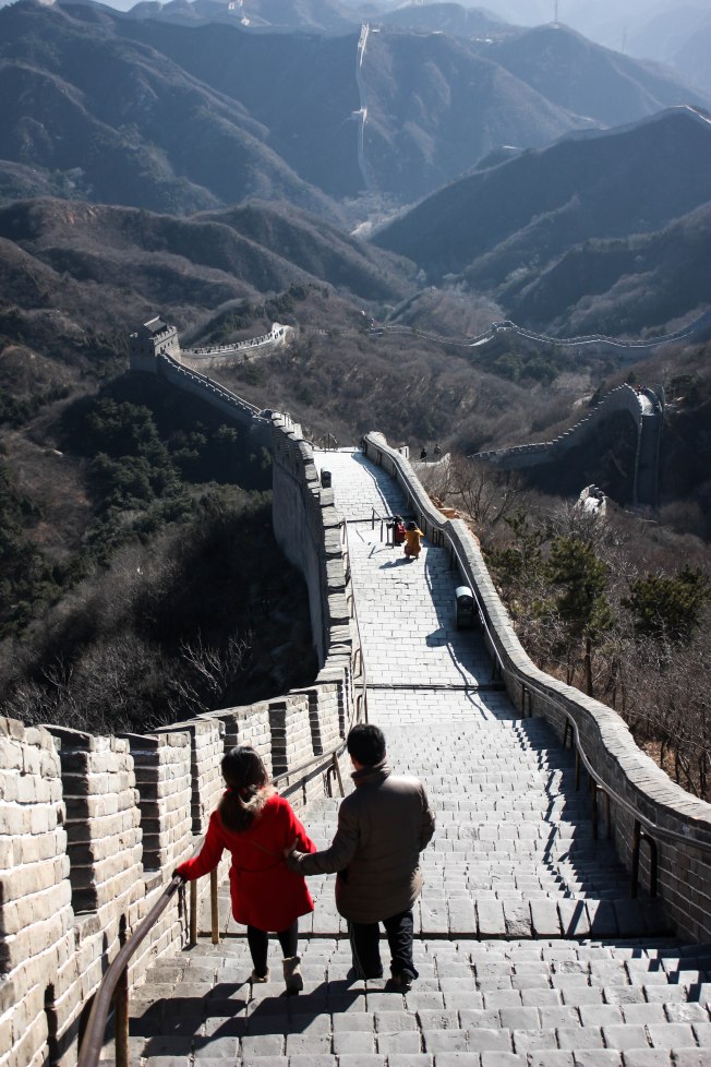 Couple hiking down the Great wall of China